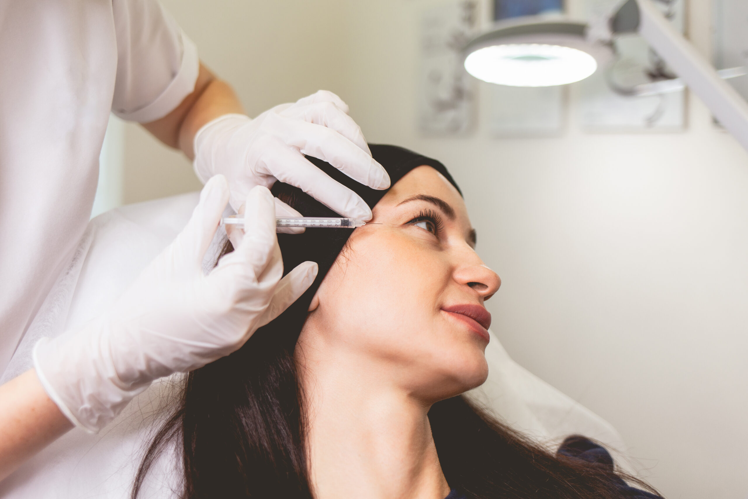 Cosmetologist makes anti-aging injections for her patient. Woman takes care of herself and does rejuvenating facial injections